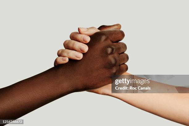 interracial arm wrestling - arm wrestle stock pictures, royalty-free photos & images