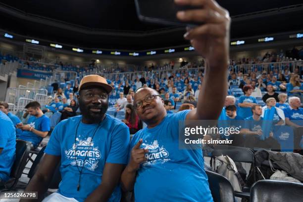 spectator taking selfie - basketball all access stock pictures, royalty-free photos & images