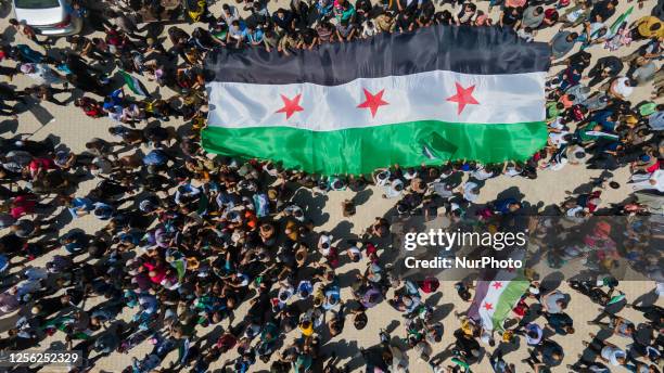 Syrian opposition protesters rally in the city of Afrin, northwest of Syria, condemning the Arab League's initiative to invite the Syrian regime's...