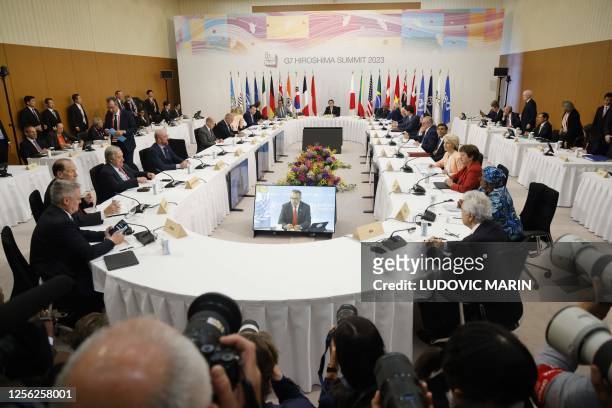 Japan's Prime Minister Fumio Kishida hosts a working session as part of the G7 Leaders' Summit in Hiroshima on May 20, 2023.