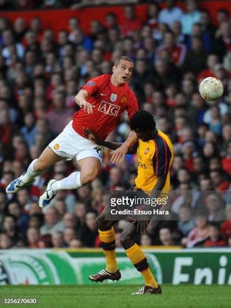 Nemanja Vidic of Manchester United and Emmanuel Adebayor of Arsenal compete for the ball during the UEFA Champions League semi final first leg match...