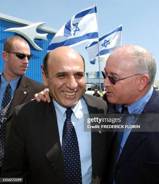 Israel's Defence Minister Shaoul Mofaz chats with an unidentified person on the Israeli stand at the Paris Air Show at Le Bourget airport, 16 June...