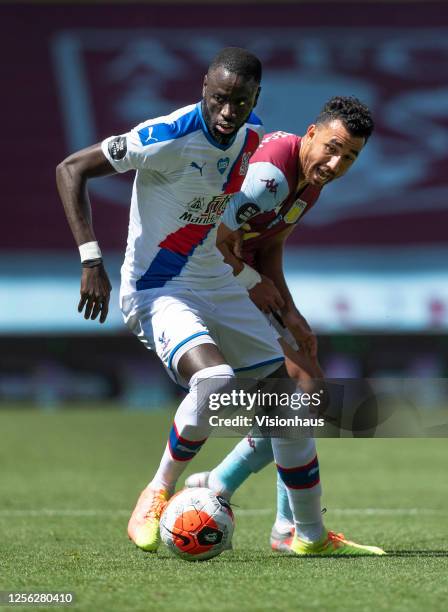 Cheikhou Kouyate of Crystal Palace and Mahmoud Trezeguet of Aston Villa in action during the Premier League match between Aston Villa and Crystal...