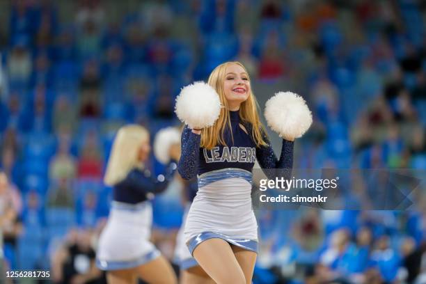 cheerleader performing on court - cheerleading competition stock pictures, royalty-free photos & images