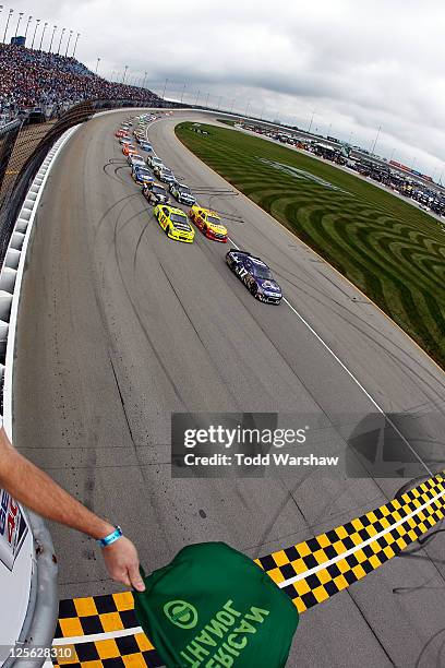 Matt Kenseth, driver of the Crown Royal Ford, and Paul Menard, driver of the Zecol/Menards Chevrolet, lead the field to the green flag to start the...