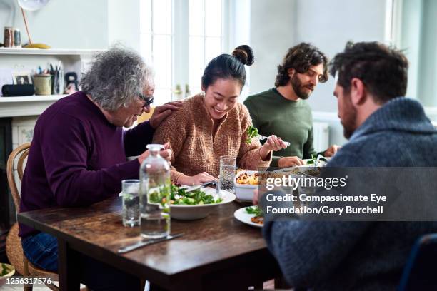 extended family having meal together - family dinner table stock pictures, royalty-free photos & images