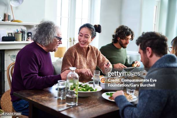 extended family having meal together - table discussion stock pictures, royalty-free photos & images