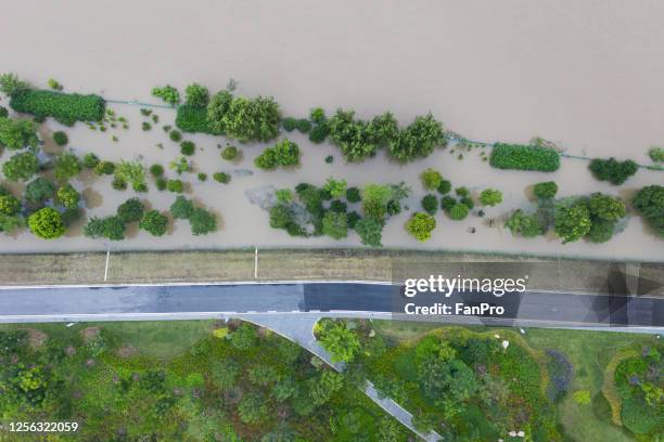 aerial view of dyke flooded - embankment stock-fotos und bilder