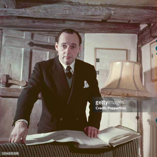 British speed record breaker Donald Campbell posed with a folder of technical documents at his house 'Abbotts' in the village of Leigh in Surrey,...