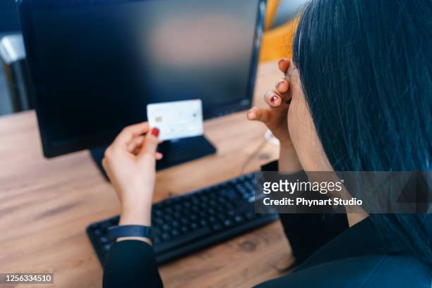 worried executive paying with card on compiter - identity fraud stock pictures, royalty-free photos & images