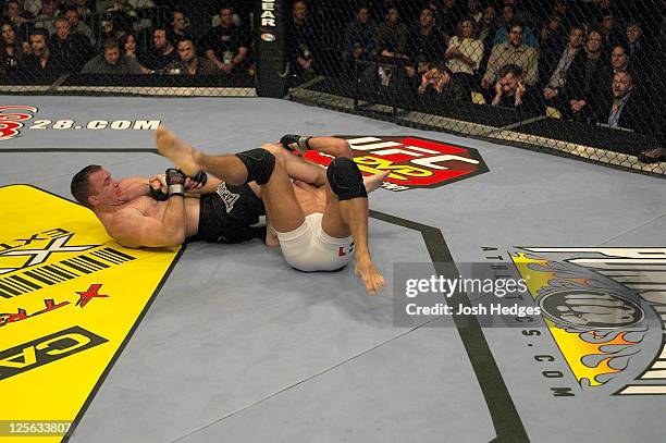 Matt Hughes secures an arm bar submission against Georges St-Pierre during their welterweight championship bout at UFC 50 at the Boardwalk Hall on...