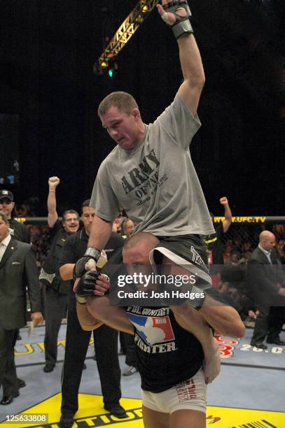 Matt Hughes is hoisted up on Georges St-Pierre's shoulders after Hughes defeated St-Pierre in their welterweight championship bout at UFC 50 at the...