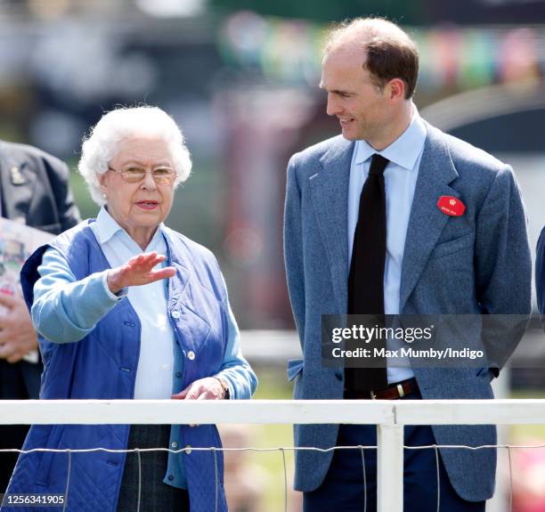 Queen Elizabeth II watches her horse 'Barber's Shop' compete in the Tattersalls and Ror Thoroughbred Ridden Show Class on day 3 of the Royal Windsor...