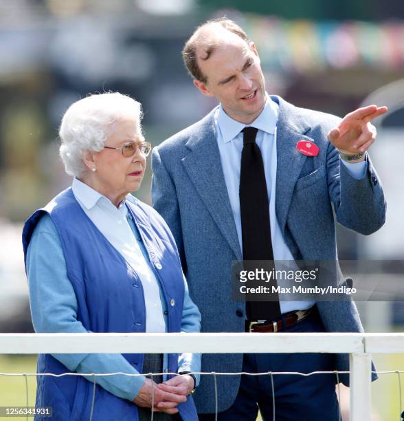 Queen Elizabeth II watches her horse 'Barber's Shop' compete in the Tattersalls and Ror Thoroughbred Ridden Show Class on day 3 of the Royal Windsor...