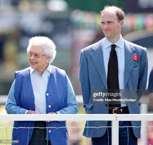 Queen Elizabeth II watches her horse 'Barber's Shop' compete in the Tattersalls and Ror Thoroughbred Ridden Show Class on day 3 of the Royal Windsor...