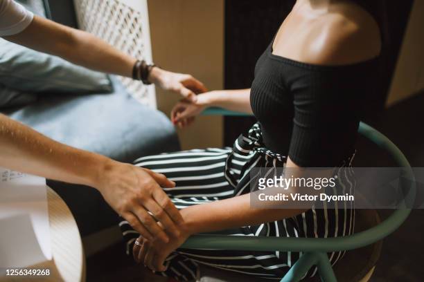 man gently touches his girlfriends soft hands - couple portrait soft ストックフォトと画像