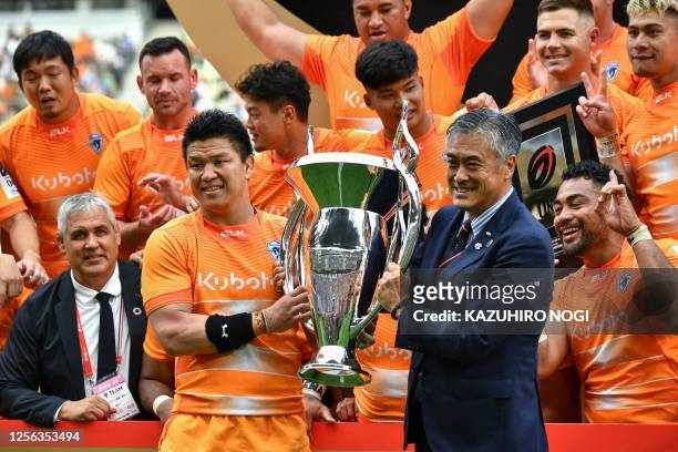 Spears Funabashi Tokyo Bay captain Harumichi Tatekawa receives the champion trophy during the awards ceremony of the League One final against Saitama...