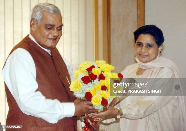 Uttar Pradesh state Chief Minister Mayawati presents a bouquet to Indian Prime Minister Atal Bihari Vajpayee before a meeting in New Delhi, 27 April...