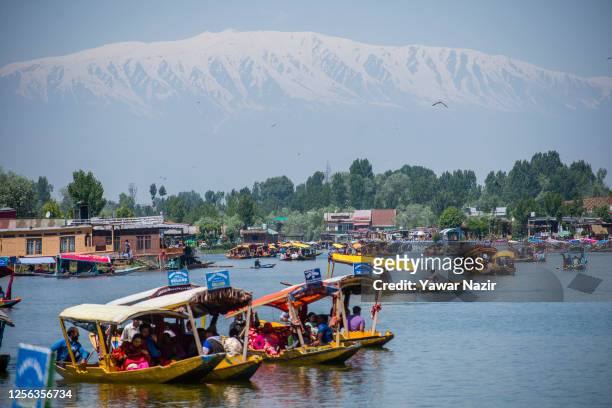 Tourists enjoy Shikara boat ride at Dal Lake ahead of the G20 summit on May 20, 2023 in Srinagar, Indian administered Kashmir, India. On May 22-24,...
