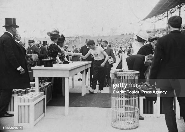 American middle-distance runner James Sullivan receives his Olympic diploma during a ceremony which followed the men's 1,500 metres event of the 1908...