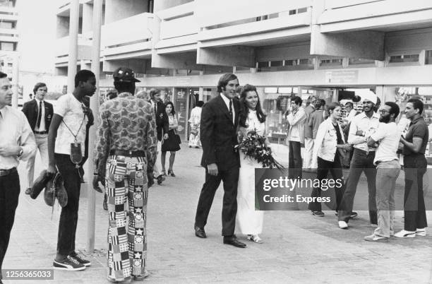 Australian water polo player David Woods and Judy Kerrison walk through the Olympic Village during the 1972 Summer Olympics, as they walk to their...