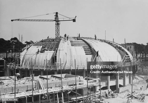 Construction workers at work on the redevelopment of the Deutsches Stadion, designed by architect Werner March to host the 1916 Summer Olympics,...