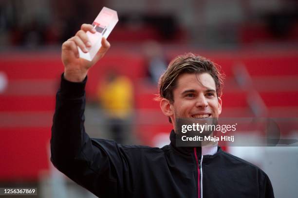 Dominic Thiem of Austria celebrates with trophy after winning the final to Matteo Berrettini of Italy during the final match of day 3 of the tennis...