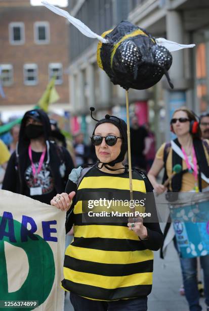 Protester marches through the city centre, wearing a bee costume and carrying the model of a bee on May 20, 2023 in Bury St Edmunds, United Kingdom....