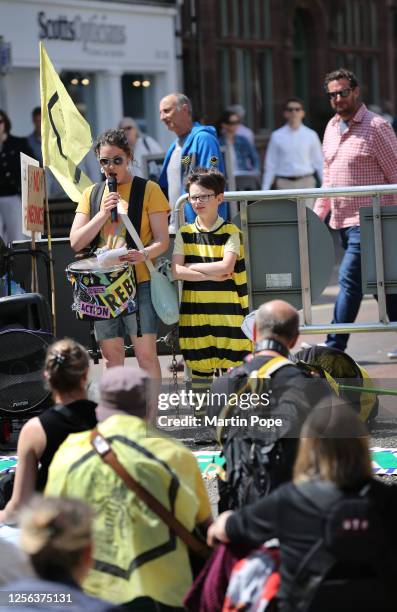 Protesters sit down in the city centre and listen to speeches about pesticides on May 20, 2023 in Bury St Edmunds, United Kingdom. On World Bee Day,...