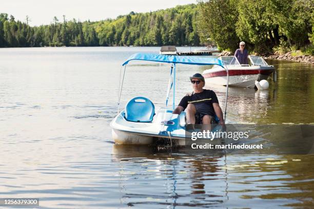 50+ couple enjoying vacations on nautical vessel. - pedal boat stock pictures, royalty-free photos & images