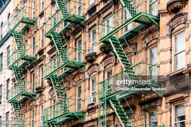 fire escape ladders on a residential building in greenwich village, new york city, usa - east village stock-fotos und bilder