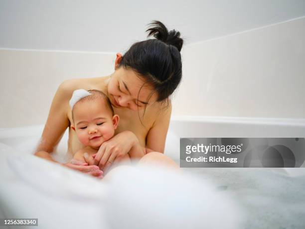 japanese mother and daughter taking a bubblebath - japanese women bath stock pictures, royalty-free photos & images