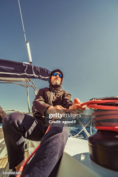 adventure man sailing on aadriatic sea - cable winch stock pictures, royalty-free photos & images