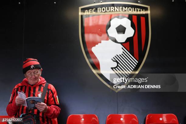 Fan reads the matchday guide ahead of the English Premier League football match between Bournemouth and Manchester United at the Vitality Stadium in...
