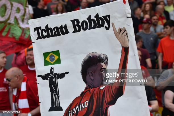 Tribute banners to Liverpool's Brazilian striker Roberto Firmino and are pictured ahead of the English Premier League football match between...