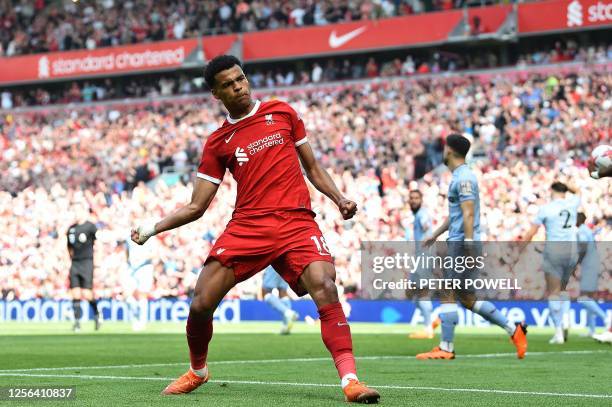 Liverpool's Dutch striker Cody Gakpo celebrates after scoring the equalising goal, but the goal was ruled out following a VAR review, due to an...