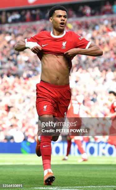 Liverpool's Dutch striker Cody Gakpo celebrates after scoring the equalising goal, but the goal was ruled out following a VAR review, due to an...