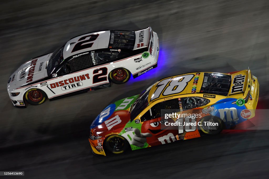 Kyle Busch, driver of the M&M's Toyota, races Brad Keselowski, driver ...