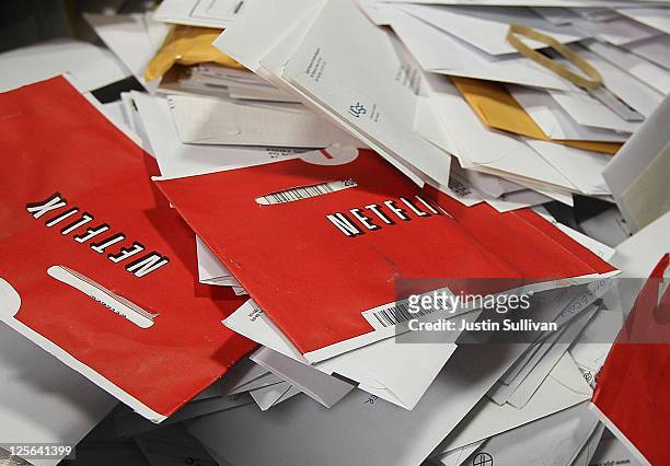 Red Netflix envelopes sit in a bin of mail at the U.S. Post Office sort center March 30, 2010 in San Francisco, California. Netflix announced...