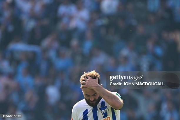 Hertha Berlin's French midfielder Lucas Tousart holds his head at the end of the German first division Bundesliga football match between Hertha...