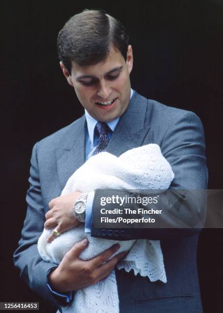 Prince Andrew with his infant daughter Princess Beatrice outside the Portland Hospital in London on 8th August 1988.