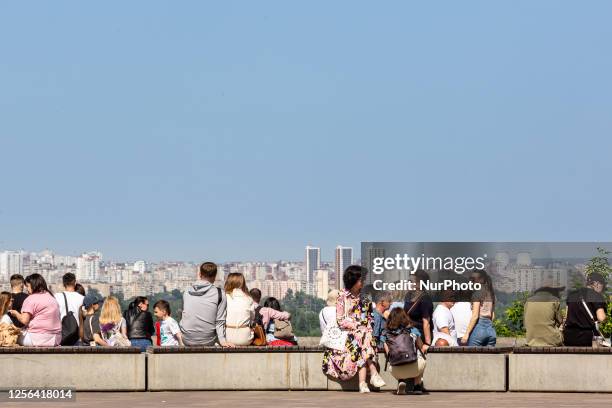 People rest and enjoy warm weather on Saturday afternoon on the famous promenade by the banks of Dnipro River in central Kyiv, the capital of Ukraine...