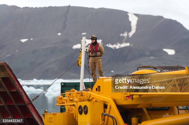 Brazilian Navy officer waiting for crane to unload container, on January 07, 2020 in King George Island, Antarctica.