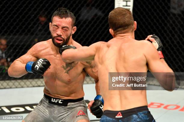 Calvin Kattar punches Dan Ige in their featherweight fight during the UFC Fight Night event inside Flash Forum on UFC Fight Island on July 16, 2020...