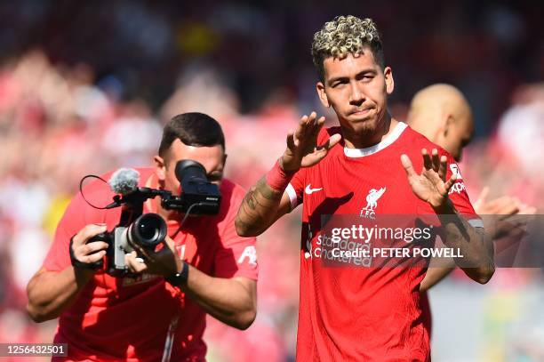 Liverpool's Brazilian striker Roberto Firmino applauds the fans following the English Premier League football match between Liverpool and Aston Villa...