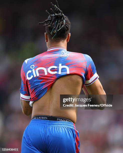 Michael Olise of Crystal Palace accidentally puts on his match shirt backwards during the Premier League match between Fulham FC and Crystal Palace...