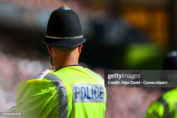 Police officer works during the Premier League match between Wolverhampton Wanderers and Everton FC at Molineux on May 20, 2023 in Wolverhampton,...