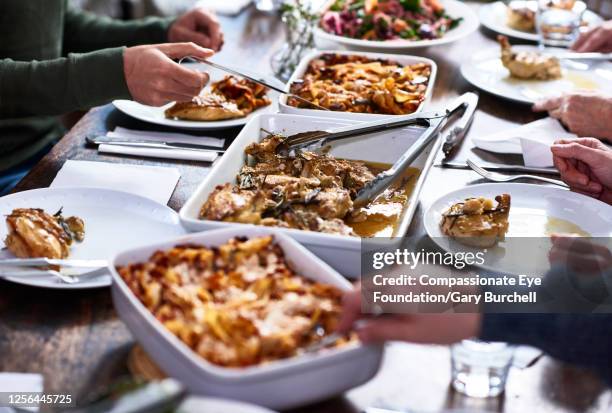 close up of multi generation family having lunch together - family food stock pictures, royalty-free photos & images