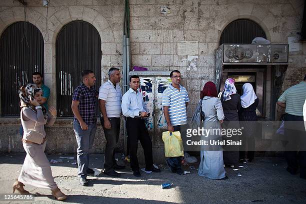 Palestinians stand in line for an ATM on September 19, 2011 in Ramallah, West Bank. Palestinian President Mahmoud Abbas is reportedly told United...