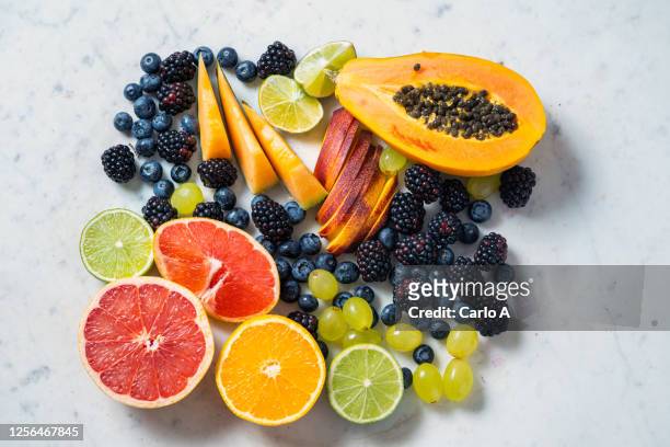 assorted fruits on a marble background. - obst stock-fotos und bilder